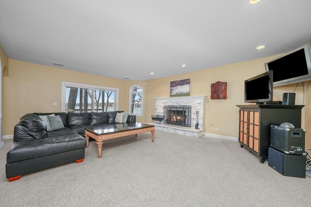 living room with carpet and a fireplace