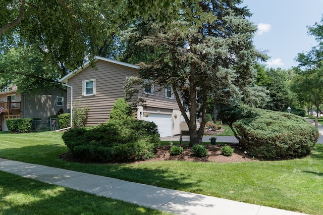 view of home's exterior featuring a yard and a garage