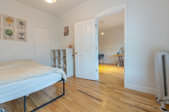 bedroom featuring crown molding and hardwood / wood-style floors