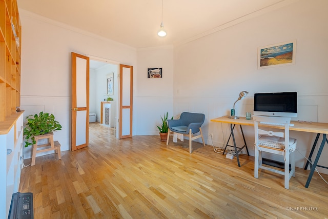 office featuring crown molding and light hardwood / wood-style flooring