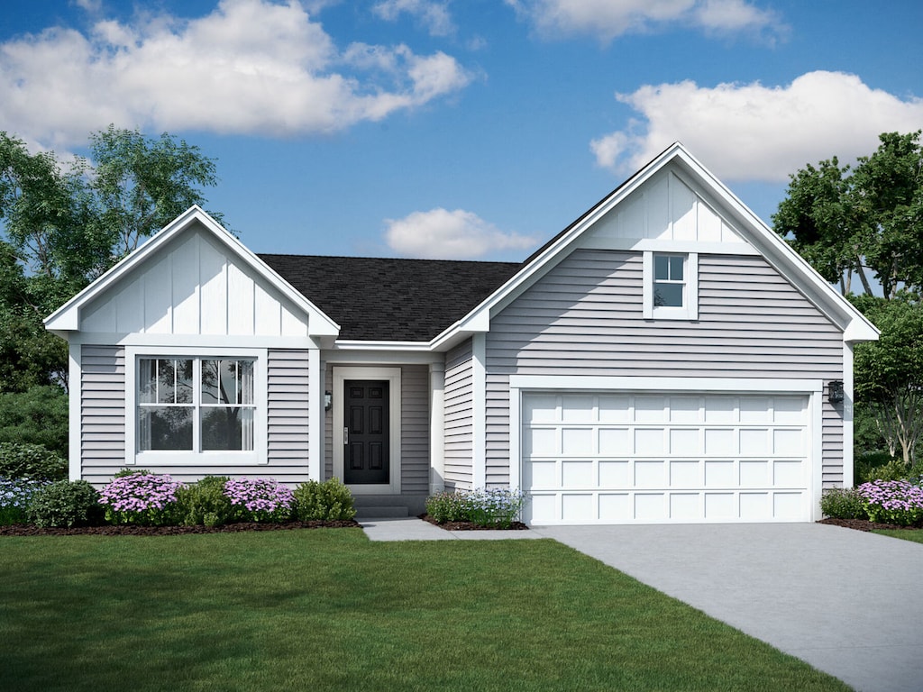 view of front of home with a front yard and a garage