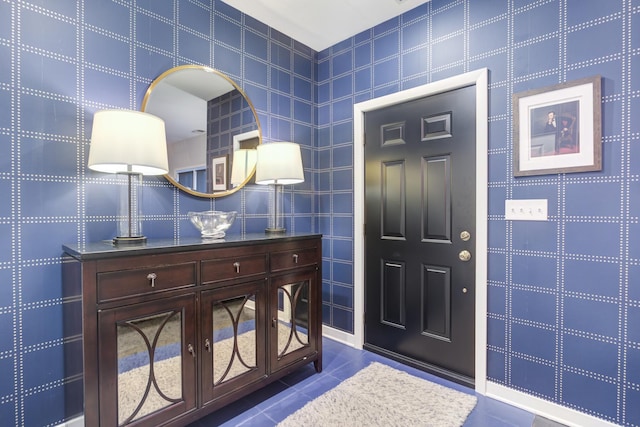 foyer entrance featuring tile patterned flooring and tile walls