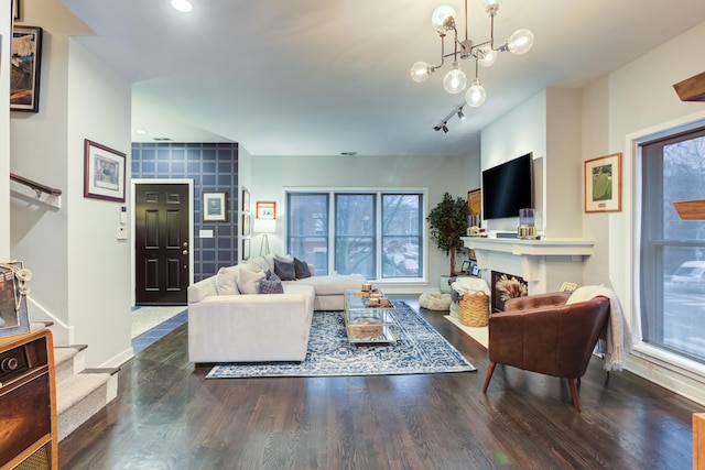 living room featuring an inviting chandelier and hardwood / wood-style flooring