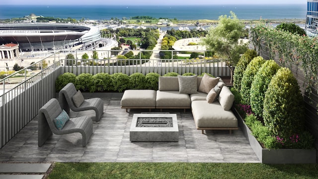 balcony featuring a water view and an outdoor living space with a fire pit