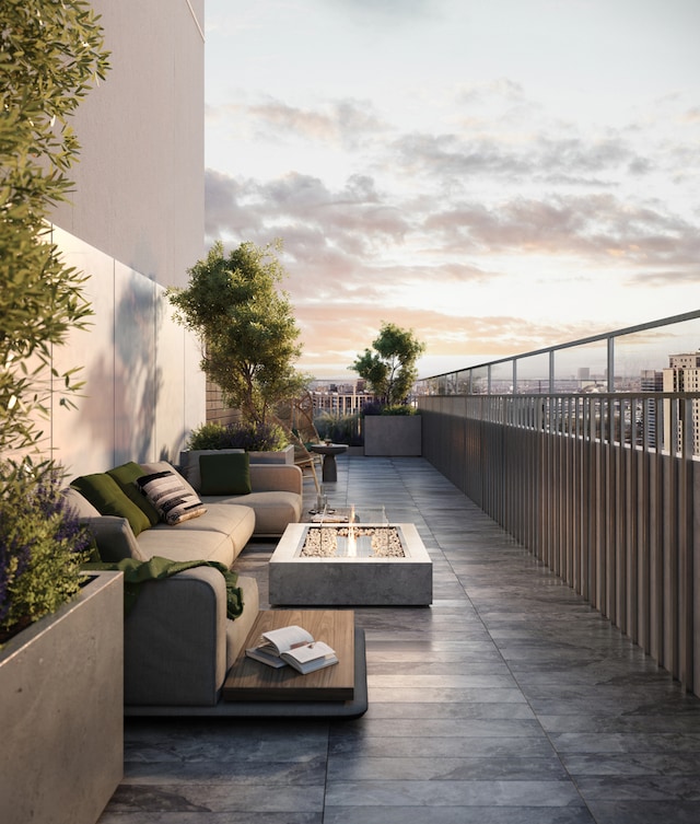 patio terrace at dusk with an outdoor living space with a fire pit