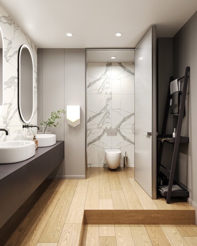 bathroom featuring vanity, hardwood / wood-style flooring, toilet, and tile walls