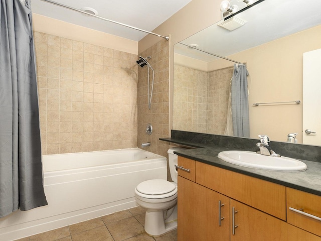 full bathroom with tile patterned floors, shower / bath combination with curtain, toilet, and vanity