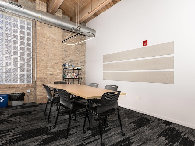 dining area with lofted ceiling with beams, wood ceiling, and brick wall