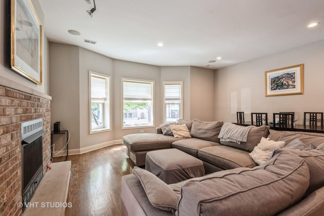 living room with a fireplace and hardwood / wood-style floors