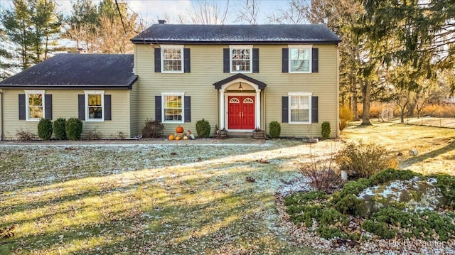 colonial inspired home with a front yard