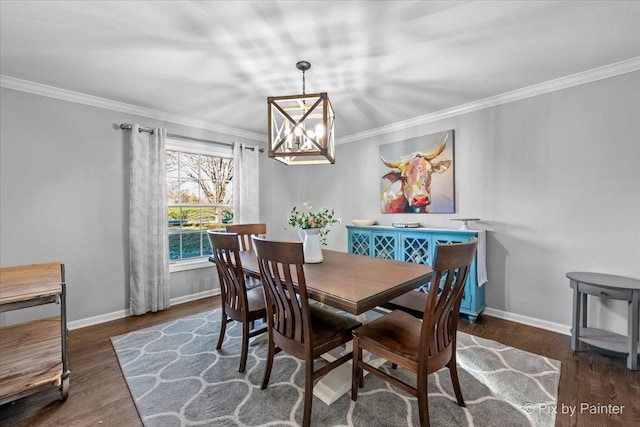 dining space featuring dark hardwood / wood-style floors, ornamental molding, and a chandelier