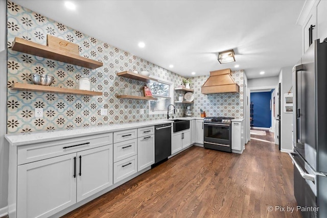 kitchen featuring custom exhaust hood, dark hardwood / wood-style floors, white cabinetry, and stainless steel appliances