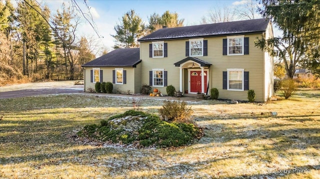 colonial inspired home with a front yard