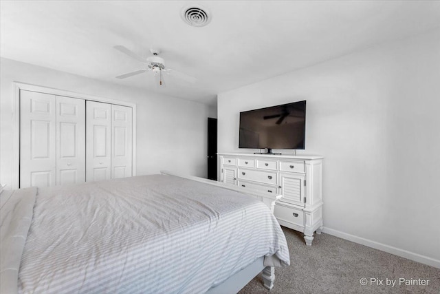 carpeted bedroom with ceiling fan and a closet