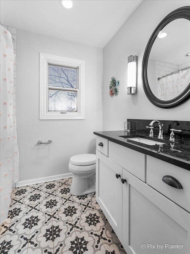 bathroom featuring tile patterned floors, vanity, and toilet