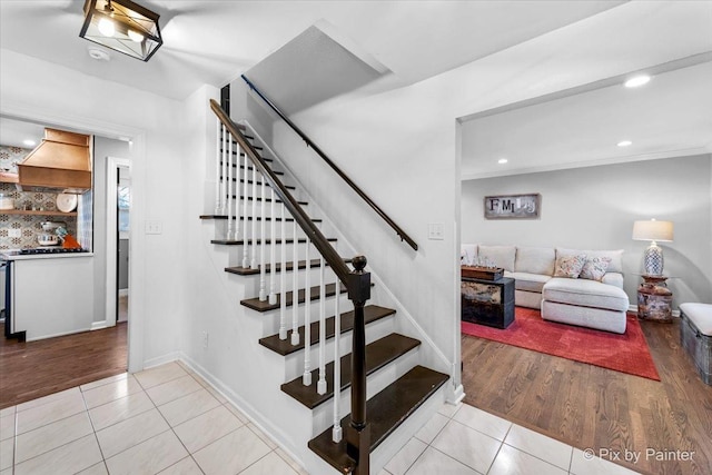 stairs featuring hardwood / wood-style flooring