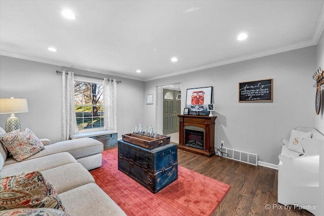 living room featuring dark hardwood / wood-style flooring and ornamental molding