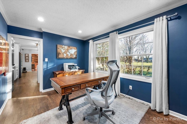 office space with dark hardwood / wood-style flooring, ornamental molding, and a textured ceiling