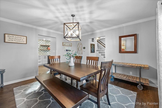 dining area featuring dark hardwood / wood-style flooring and ornamental molding