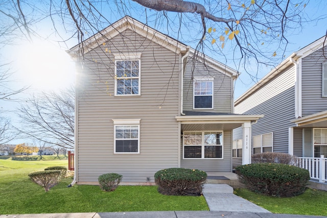 view of front property with covered porch and a front lawn