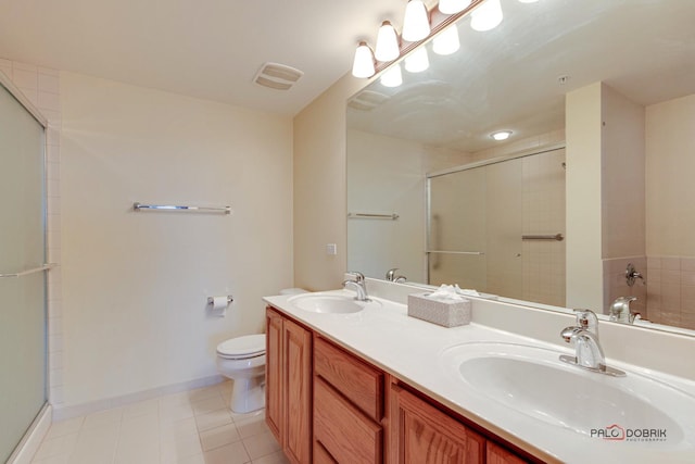 bathroom featuring tile patterned floors, a shower with door, vanity, and toilet