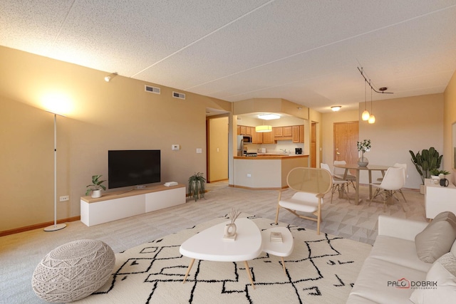 carpeted living room featuring a textured ceiling