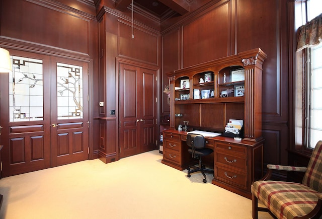 carpeted office with french doors, wooden walls, and crown molding