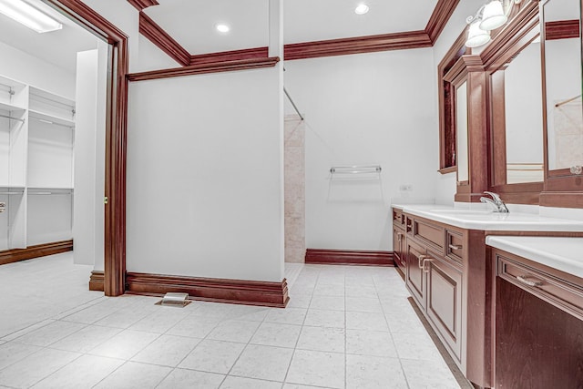 bathroom featuring crown molding and vanity