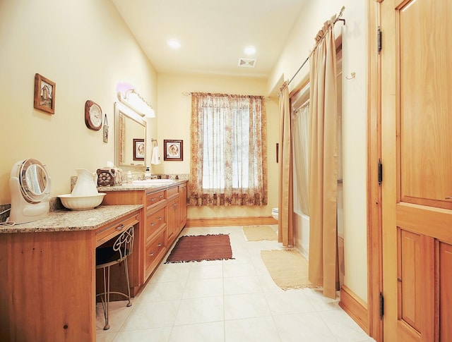 bathroom featuring tile patterned floors, vanity, and toilet