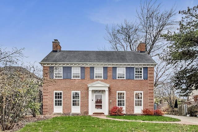 colonial inspired home with a front yard