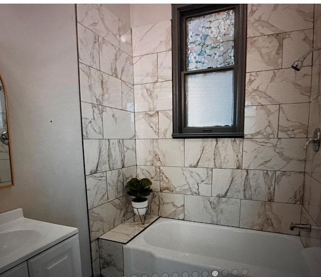 bathroom with vanity and tiled shower / bath