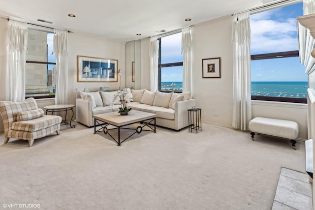 carpeted living area featuring visible vents, baseboards, and a water view