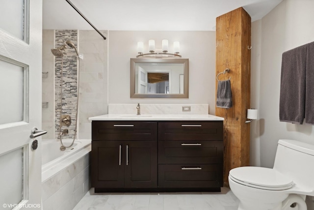 full bathroom with toilet, vanity, and tiled shower / bath