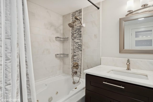 bathroom with vanity and tiled shower / bath combo