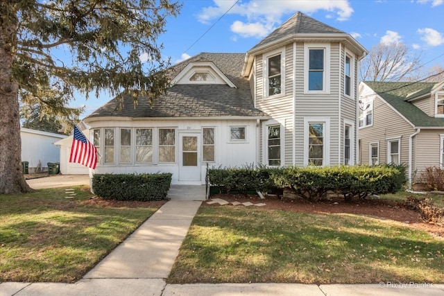 victorian-style house featuring a front yard