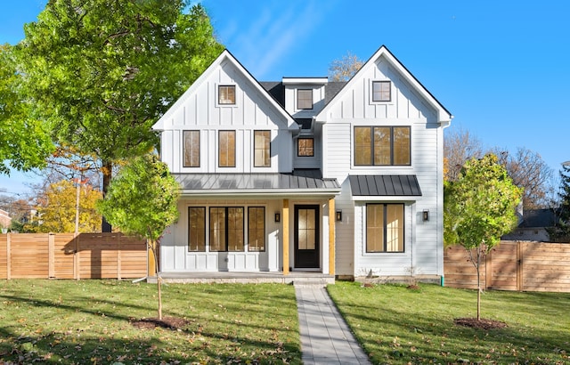 modern inspired farmhouse with covered porch and a front lawn