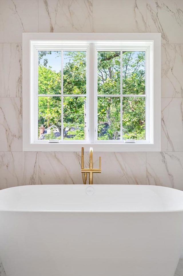 bathroom with a washtub and a wealth of natural light