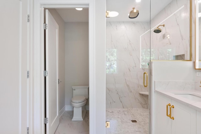 bathroom featuring a shower with door, vanity, and toilet