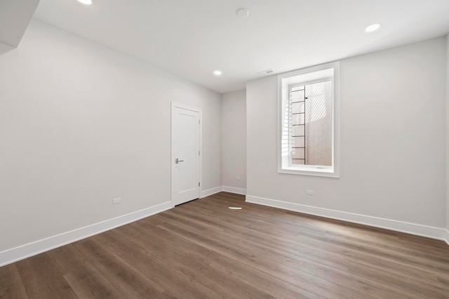 spare room featuring dark wood-type flooring