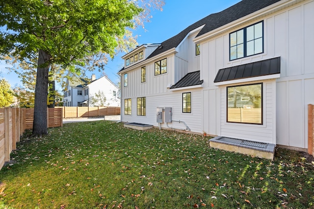 rear view of house featuring a lawn