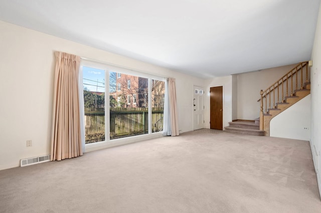 unfurnished living room featuring carpet flooring