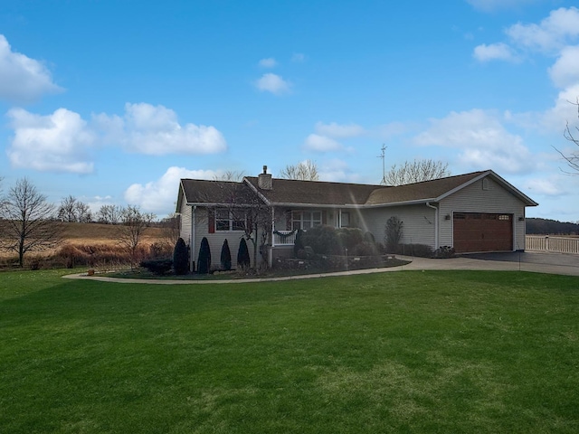 view of front of property with a front yard and a garage