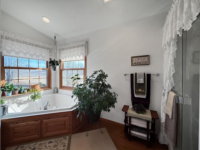 bathroom with separate shower and tub and vaulted ceiling