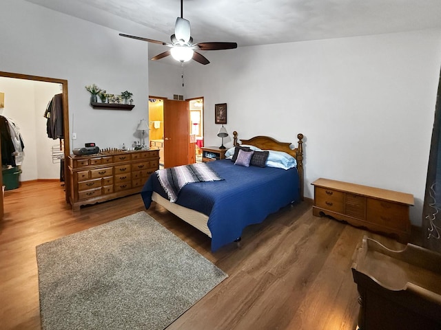 bedroom with hardwood / wood-style flooring, ceiling fan, and lofted ceiling