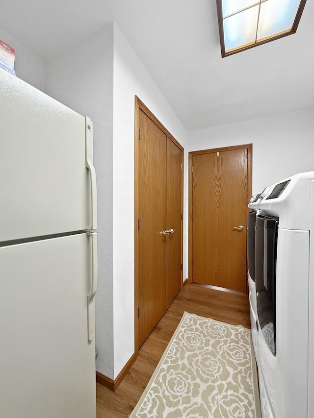 washroom featuring light hardwood / wood-style floors and independent washer and dryer