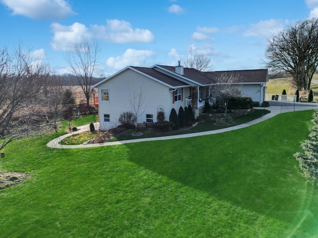 view of home's exterior with a lawn and a garage