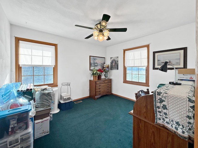 home office featuring ceiling fan and dark carpet