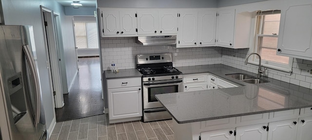 kitchen featuring white cabinets, sink, light hardwood / wood-style flooring, kitchen peninsula, and stainless steel appliances