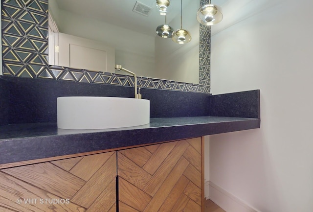 bathroom with tasteful backsplash and sink