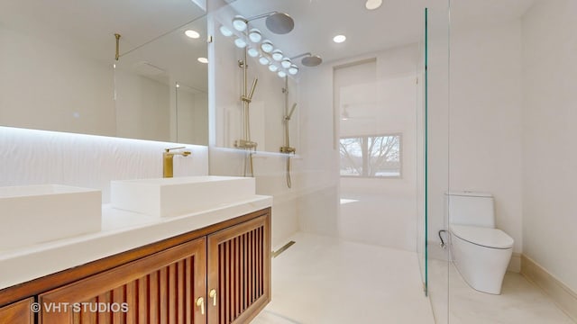 bathroom featuring a shower, vanity, and toilet